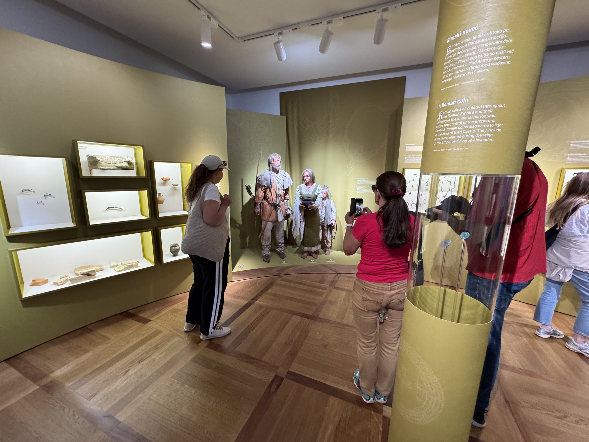 Visitors photographing the 9th-century Slavic family at Bled Castle