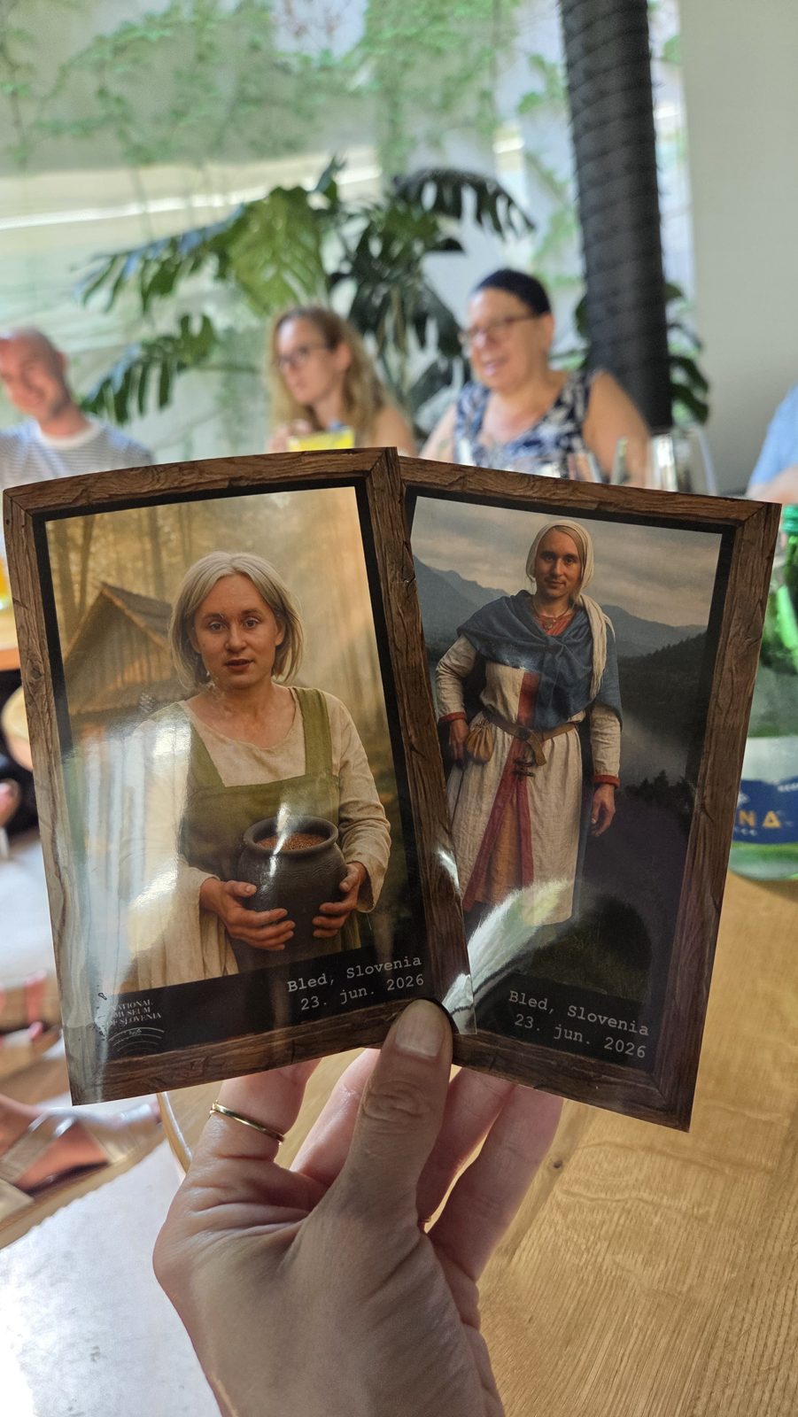 A hand holding two printed AI-generated portraits