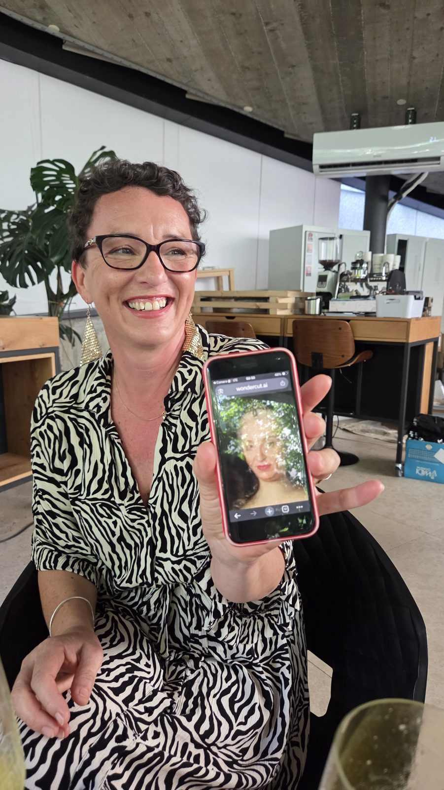 A participant showing her AI-generated portrait on a phone